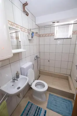a bathroom with a white toilet and a sink at GOOD People in Bihać