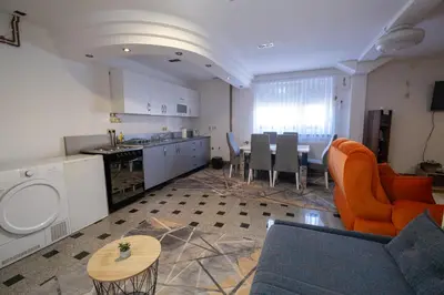 a living room with a kitchen and a dining room at GOOD People in Bihać