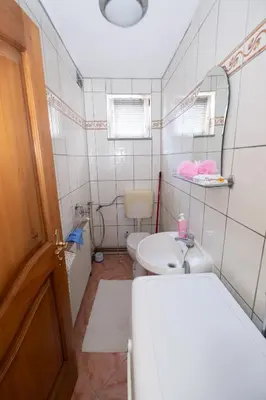 a bathroom with a toilet and a sink and a mirror at GOOD People in Bihać