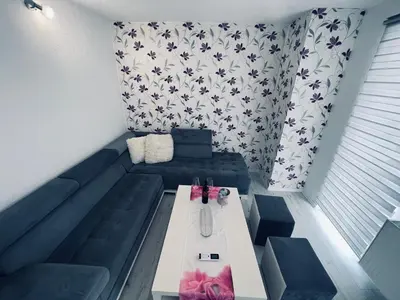 a living room with a blue couch and a table at Stan 7 in Kiseljak