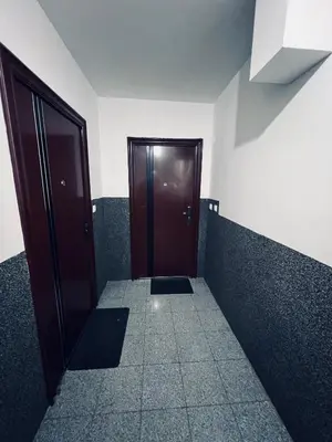 a hallway with a brown door in a room at Stan 7 in Kiseljak