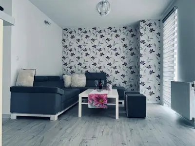 a living room with a blue couch and a table at Stan 7 in Kiseljak