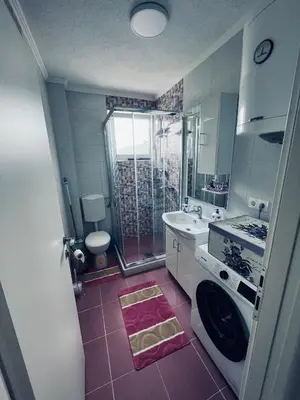 a bathroom with a sink and a washing machine at Stan 7 in Kiseljak