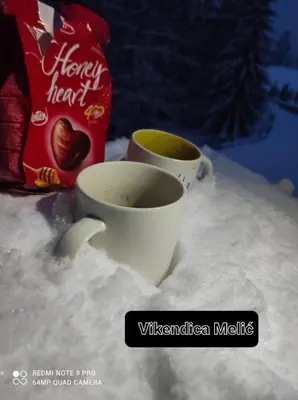 two cups of coffee sitting in the snow at Vikendica Amra i Indir in Travnik
