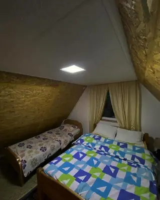 a small bedroom with a bed in a room at Vikendica Amra i Indir in Travnik