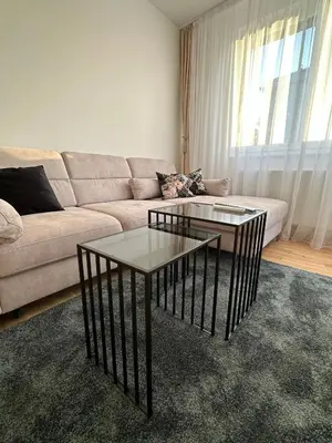 a living room with two tables and a couch at Apartman EMA in Banja Luka