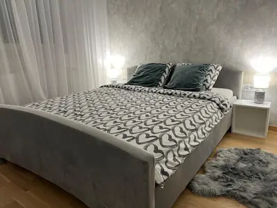 a large bed in a bedroom with a rug at Apartman EMA in Banja Luka