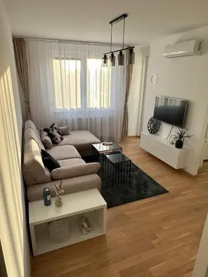 a living room with a couch and a tv at Apartman EMA in Banja Luka