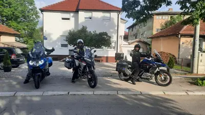 three motorcycles parked on the side of a street at 7 Kućica in Livno