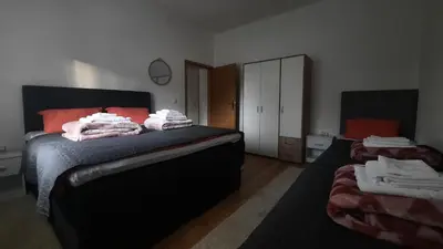 a bedroom with a bed with towels on it at 7 Kućica in Livno