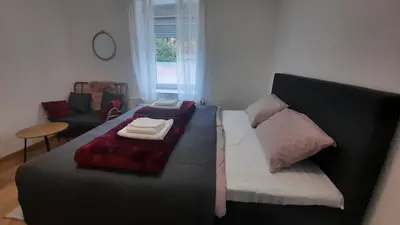 a bedroom with a bed with towels on it at 7 Kućica in Livno