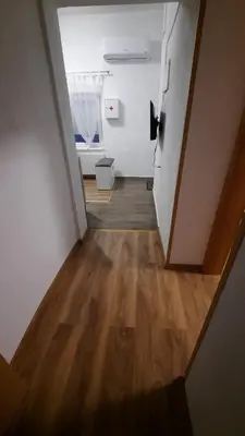 a hallway of an empty room with wooden floors at 7 Kućica in Livno