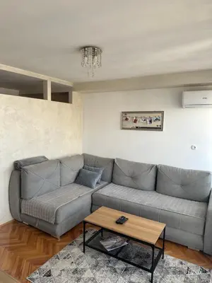 a living room with a couch and a coffee table at Apartman Nira in Zenica