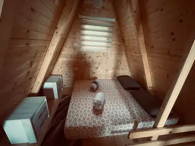 an overhead view of a bed in a wooden attic at Vikendica VIDIKOVAC na Piramidi Sunca in Visoko