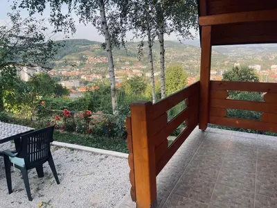 a wooden porch with a bench and a view at Vikendica VIDIKOVAC na Piramidi Sunca in Visoko