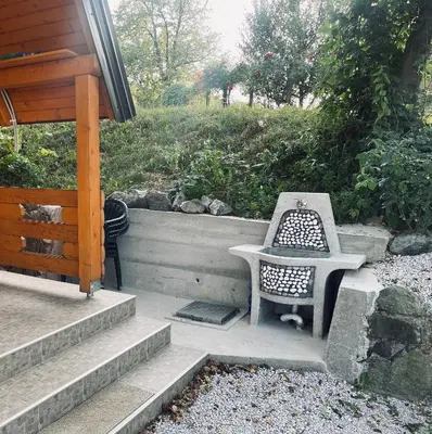 a table and a chair sitting on a patio at Vikendica VIDIKOVAC na Piramidi Sunca in Visoko