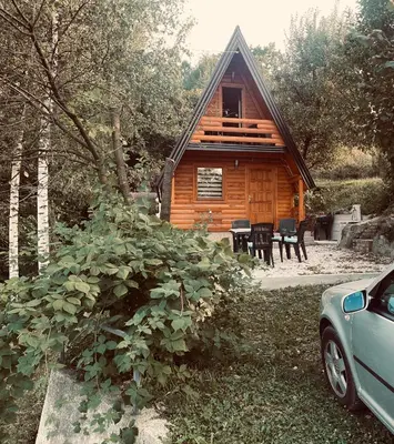 a log cabin with a car parked in front of it at Vikendica VIDIKOVAC na Piramidi Sunca in Visoko