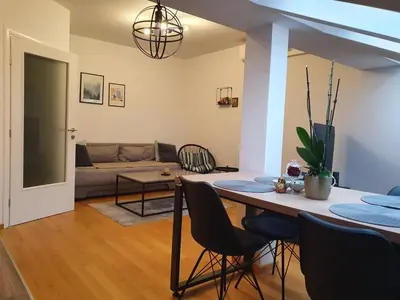 a living room with a table and a couch at Apartman RedBrick in Banja Luka
