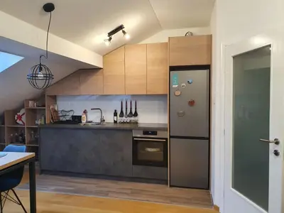 a kitchen with a stainless steel refrigerator and a stove at Apartman RedBrick in Banja Luka