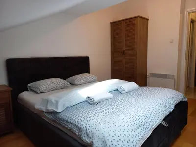 a bedroom with a bed with two towels on it at Apartman RedBrick in Banja Luka