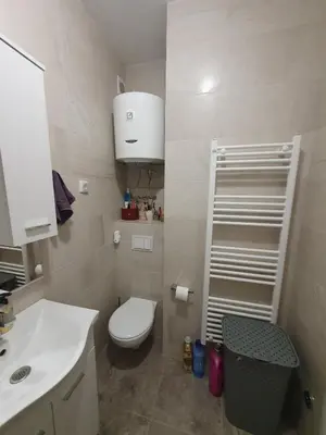 a small bathroom with a toilet and a sink at Apartman RedBrick in Banja Luka