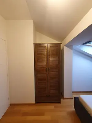 a room with a wooden closet in a bedroom at Apartman RedBrick in Banja Luka