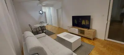 a living room with a couch and a tv at Apartmani ANNA in Banja Luka
