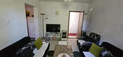 a living room with two couches and a television at Apartman Hushida in Bihać