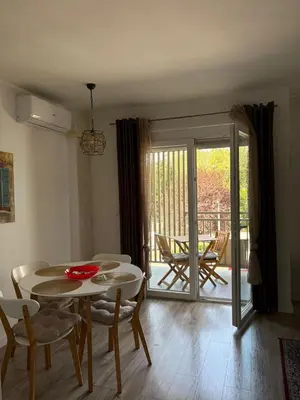 a living room with a table and chairs and a patio at Apartman VIVA in Bihać