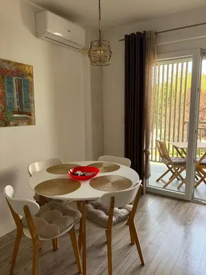 a dining room with a white table and chairs at Apartman VIVA in Bihać