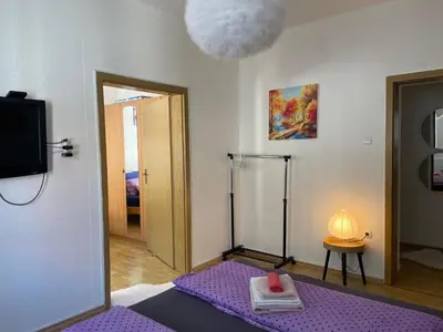 a room with a purple bed and a tv at Anna in Livno