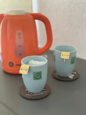 two coffee cups and a tea kettle on a counter at Anna in Livno
