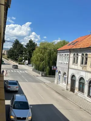 a street with cars parked next to a building at Anna in Livno