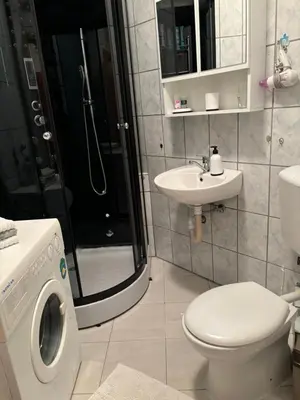 a bathroom with a washing machine and a sink at Anna in Livno