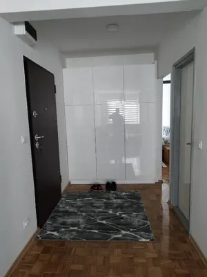 a room with a shower and a black rug at Apartman Sandi in Novi Travnik