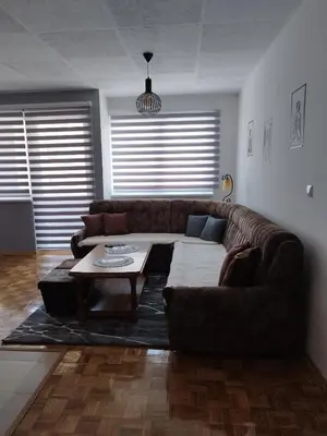a living room with a couch and a coffee table at Apartman Sandi in Novi Travnik
