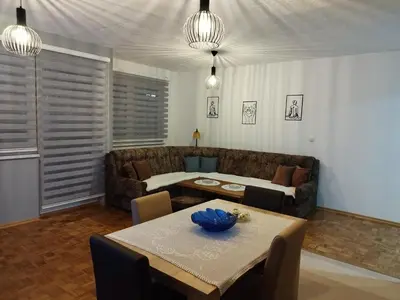 a living room with a couch and a table at Apartman Sandi in Novi Travnik