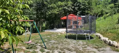 a playground with a batting cage and a house at Eko kuca Jandro in Šipovo