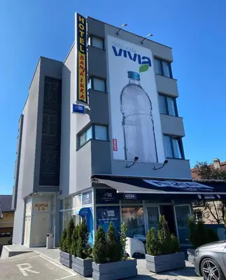 a large building with a large bottle of water on it at Hotel Banja Luka in Banja Luka