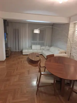a living room with a white couch and tables at PENTHAUS apartment in Banja Luka