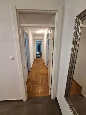 a hallway in a house with a mirror at PENTHAUS apartment in Banja Luka