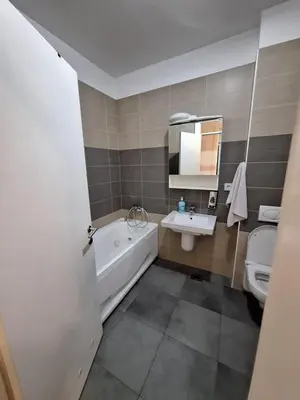 a bathroom with a tub and a sink and a toilet at PENTHAUS apartment in Banja Luka