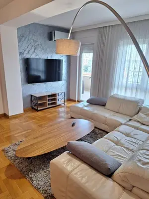 a living room with a couch and a table at PENTHAUS apartment in Banja Luka