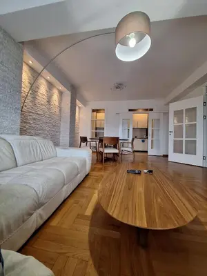 a living room with a white couch and a wooden table at PENTHAUS apartment in Banja Luka
