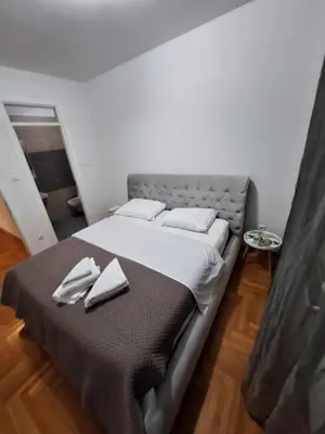 a bedroom with a bed with two towels on it at PENTHAUS apartment in Banja Luka