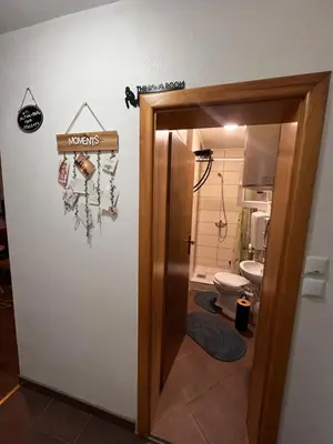 a bathroom with a toilet and a sign that reads towels at ALBAK Green Zone in Gradačac