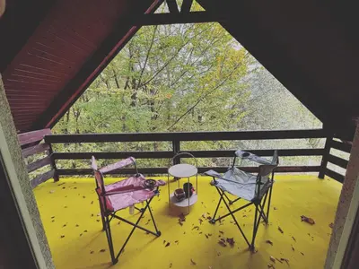 two chairs and a table on a porch at ALBAK Green Zone in Gradačac