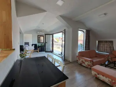 a living room with a couch and a table in it at Apartman Gradina in Doboj