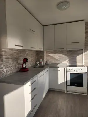 a white kitchen with white cabinets and a stove at Stan na dan Nova Varoš in Banja Luka