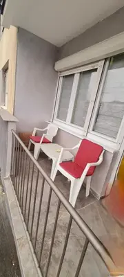 two chairs and a table on a balcony at LARA S in Banja Luka